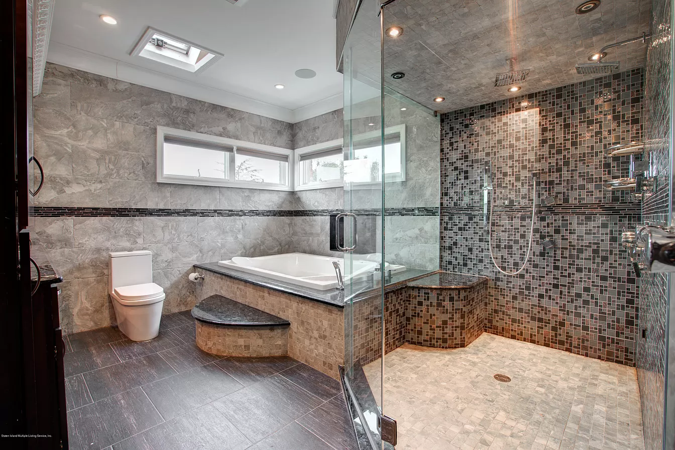 Spa bathroom with glass shower, mosaic tile, and soaking tub